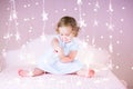 Funny toddler girl between beautiful pink lights Royalty Free Stock Photo