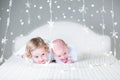 Funny toddler girl and her newborn baby brother relaxing together Royalty Free Stock Photo