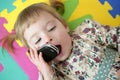 Funny toddler girl talking mobile cell phone