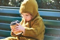 Funny toddler kid holding paper cup of take away coffee