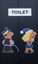 Funny toilet sign, man pee and girl have to hurry to pee