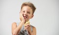 Funny toothless boy with sensitive teeth holding ice cream