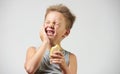 Funny toothless boy with sensitive teeth holding ice cream Royalty Free Stock Photo