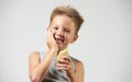 Funny toothless boy with sensitive teeth holding ice cream