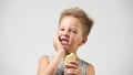 Funny toothless boy with sensitive teeth holding ice cream Royalty Free Stock Photo