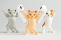 Funny toy cats advertise white wireless tws headphones. Unusual stand for tws headphones. Photo. Selective focus