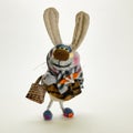 Funny toy hare dressed in headscarves with shopping bags