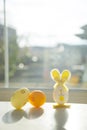 Funny toy rabbit with colorful easter eggs on window