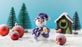 Toy snowman and red balls on fake snow near small house in decorative forest Royalty Free Stock Photo