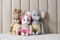 Toy unicorn, deer and elephant on bed. Decor for children`s room interior