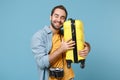 Funny traveler tourist man in casual clothes with photo camera isolated on blue background. Male passenger traveling Royalty Free Stock Photo