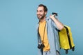 Funny traveler tourist man in casual clothes with photo camera isolated on blue background. Male passenger traveling Royalty Free Stock Photo