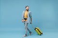 Funny traveler tourist man in yellow casual clothes with photo camera isolated on blue background. Male passenger Royalty Free Stock Photo