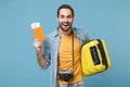 Funny traveler tourist man in yellow clothes with photo camera isolated on blue background. Male passenger traveling Royalty Free Stock Photo