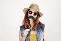 Funny trendy fashion girl with paper mustache playing with emotion Royalty Free Stock Photo