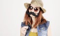 Funny trendy hipster girl with paper mustache playing with emotion Royalty Free Stock Photo