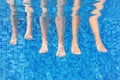 Funny underwater family legs in swimming pool, under water view of mother and kids, vacation and sport