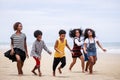 Funny vacation. Children or kids playing and romp together at the beach on holiday. Having fun after unlocking down the city from Royalty Free Stock Photo