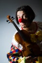 The funny violin clown player in musical concept