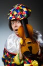 The funny violin clown player in musical concept