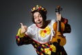 Funny violin clown player in musical concept