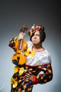 The funny violin clown player in musical concept