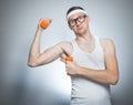 Funny weak man lifting biceps Royalty Free Stock Photo