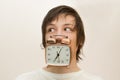 Funny white man hold in mouth alarm clock Royalty Free Stock Photo