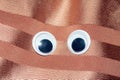 Funny Wiggle Google Eyes on Fabric Background