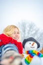 Funny winter girl playing with snow in park on white snow background. Outdoor portrait of young pretty beautiful woman Royalty Free Stock Photo