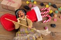 The witch Befana and red stocking with sweet coal and candy on rustic wooden background. Italian Epiphany day tradition Royalty Free Stock Photo