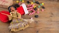 The witch Befana and red stocking with sweet coal and candy on rustic wooden background. Italian Epiphany day tradition