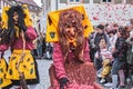Funny witch throws red confetti in the air. Street Carnival in Southern Germany - Black Forest