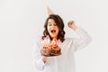 a funny woman with a birthday cake with candles.