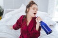 Charming funny woman singing holding bottle of wine