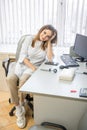 Funny woman dermatologist with dermatoscope in uniform and gloves in doctor office on workplace with computer