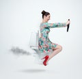 Funny woman in dress flying on the toilet with steering wheel. Concept of movement