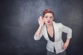 Funny woman eavesdrop on blackboard background Royalty Free Stock Photo