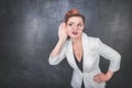 Funny woman eavesdrop on blackboard background