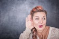 Funny woman eavesdrop on blackboard background