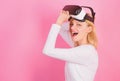 Funny woman experiencing 3D gadget technology - close up. Woman using virtual reality headset. Happy woman exploring Royalty Free Stock Photo