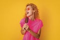 funny woman with icelolly ice cream isolated on yellow. woman with icelolly ice cream