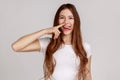 Funny woman picking nose with stupid silly face, pulling out boogers, bad manners, misconduct. Royalty Free Stock Photo