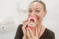 Funny woman playing with jaws in dentist clinic Royalty Free Stock Photo