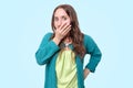 Funny woman is shocked with news covering her mouth in panic Royalty Free Stock Photo