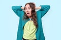 Funny woman is shocked with news holding head with hands in panic Royalty Free Stock Photo