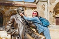 woman traveler joking with the statue of Daranyi Ignac near Vajdahunyad castle