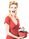 Funny woman winking in the kitchen and cooking, Royalty Free Stock Photo