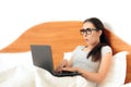 Funny Woman Working From Home On Her Laptop in Bed Royalty Free Stock Photo