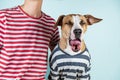 Funny yawning dog and owner in similar clothes.